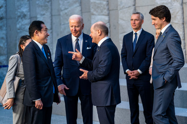 President Biden speaking with Chancellor Olaf Scholz of Germany and Prime Minister Fumio Kishida of Japan on Thursday at NATO Headquarters in Brussles.